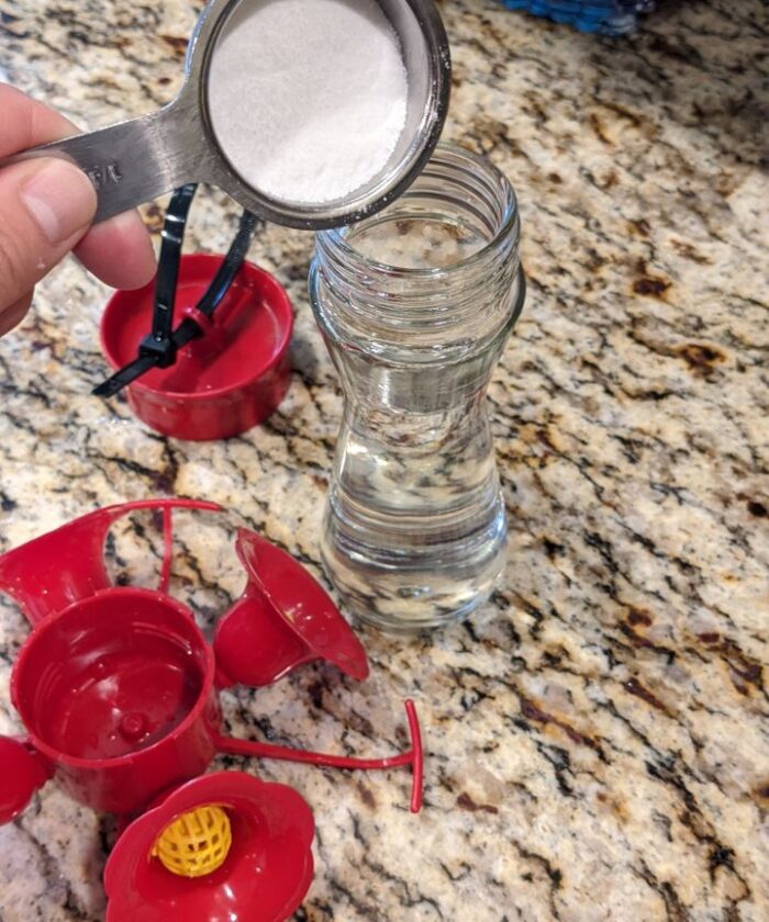 Making DIY hummingbird feeder mix.