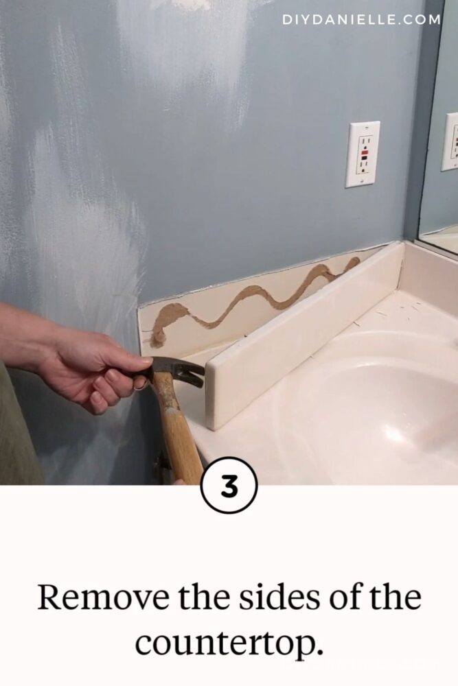 Prying off the side pieces of the countertop using a hammer.