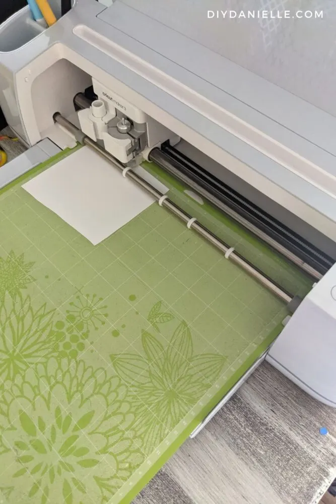 Cutting iron on vinyl with the Cricut Maker 3 on the green mat.