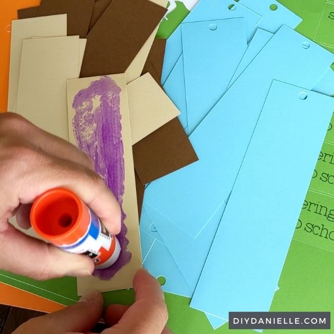 Gluing pieces of cardstock to the bookmark.