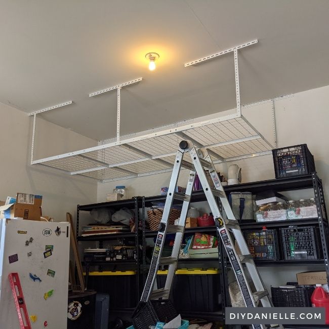 White Overhead storage rack in a garage, no items stored on it yet.