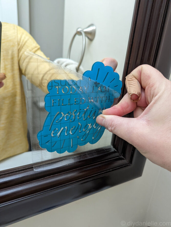 Removing transfer paper from a vinyl decal.