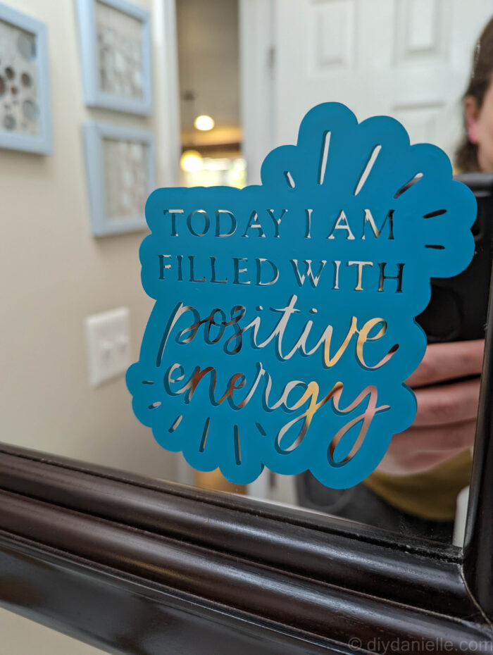 "Today I am filled with positive energy" affirmation in Cricut Permanent Vinyl on a bathroom mirror.