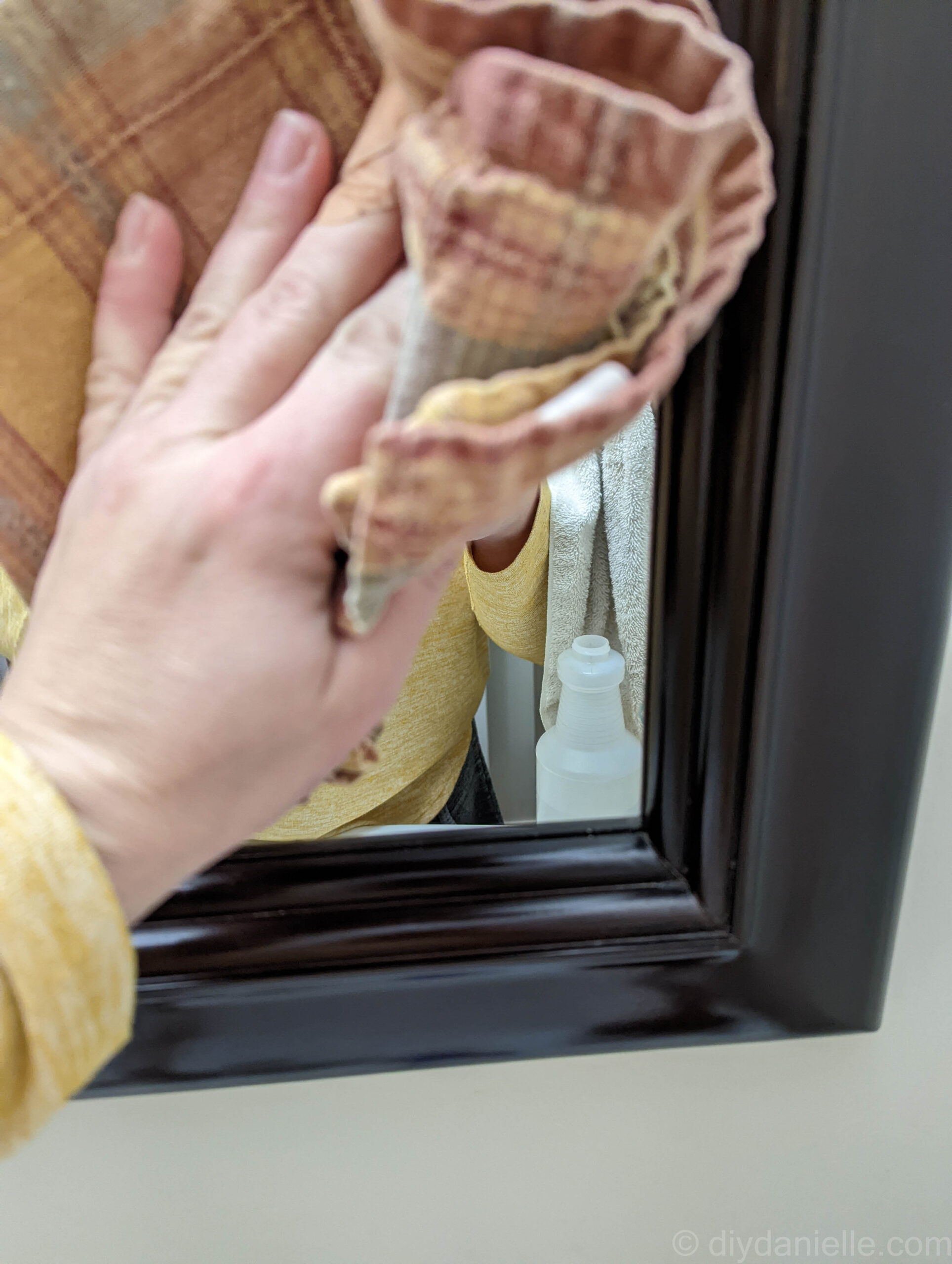 Cleaning a mirror off before attaching permanent vinyl.