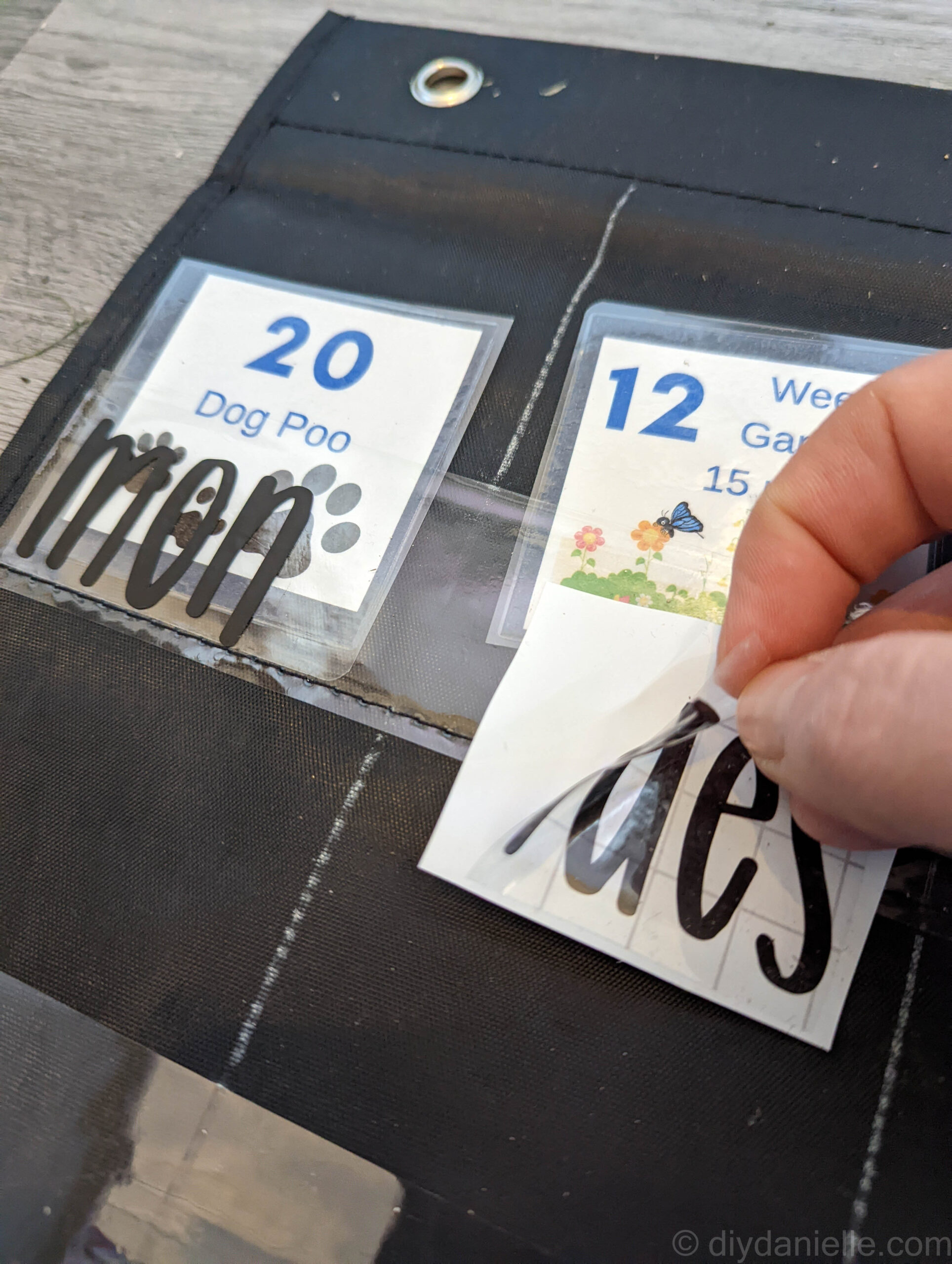 Adding permanent vinyl to the vinyl pockets of a pocket chart turned diy chore chart.