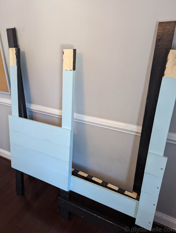 Front and the back of the toddler bed disassembled for transport.