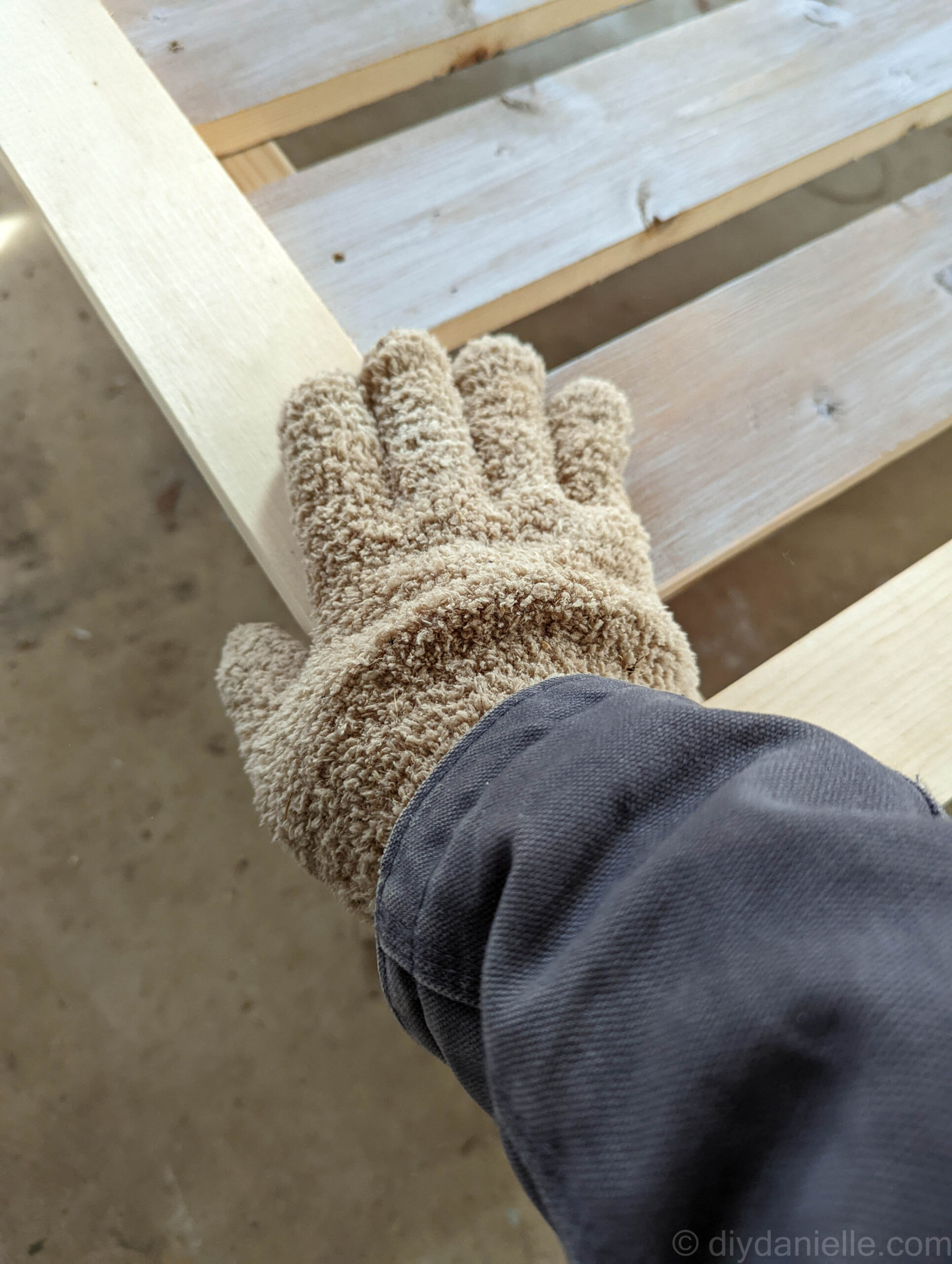 Cleaning dust off the twin bed.