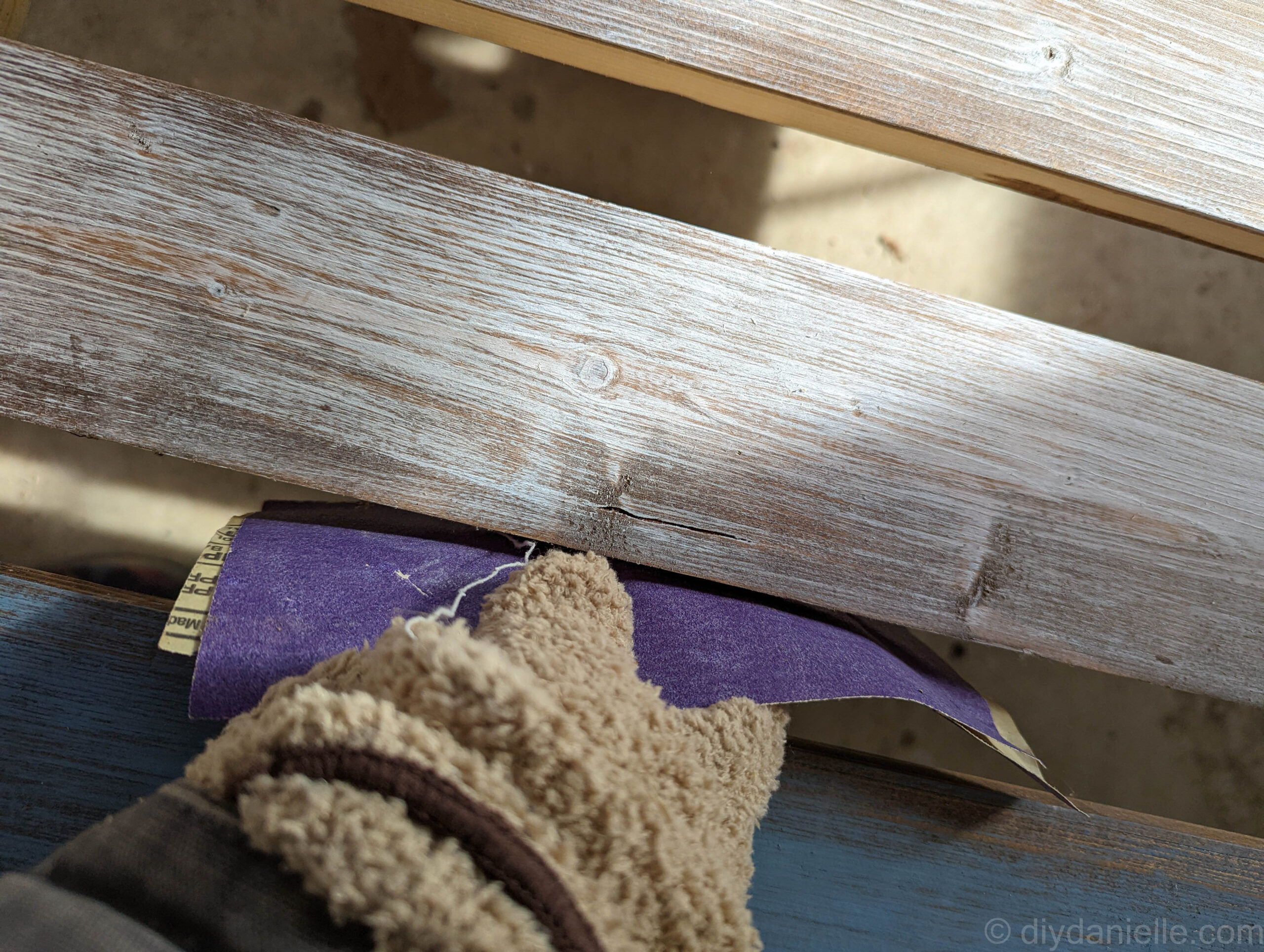Sanding the wood for the bed.