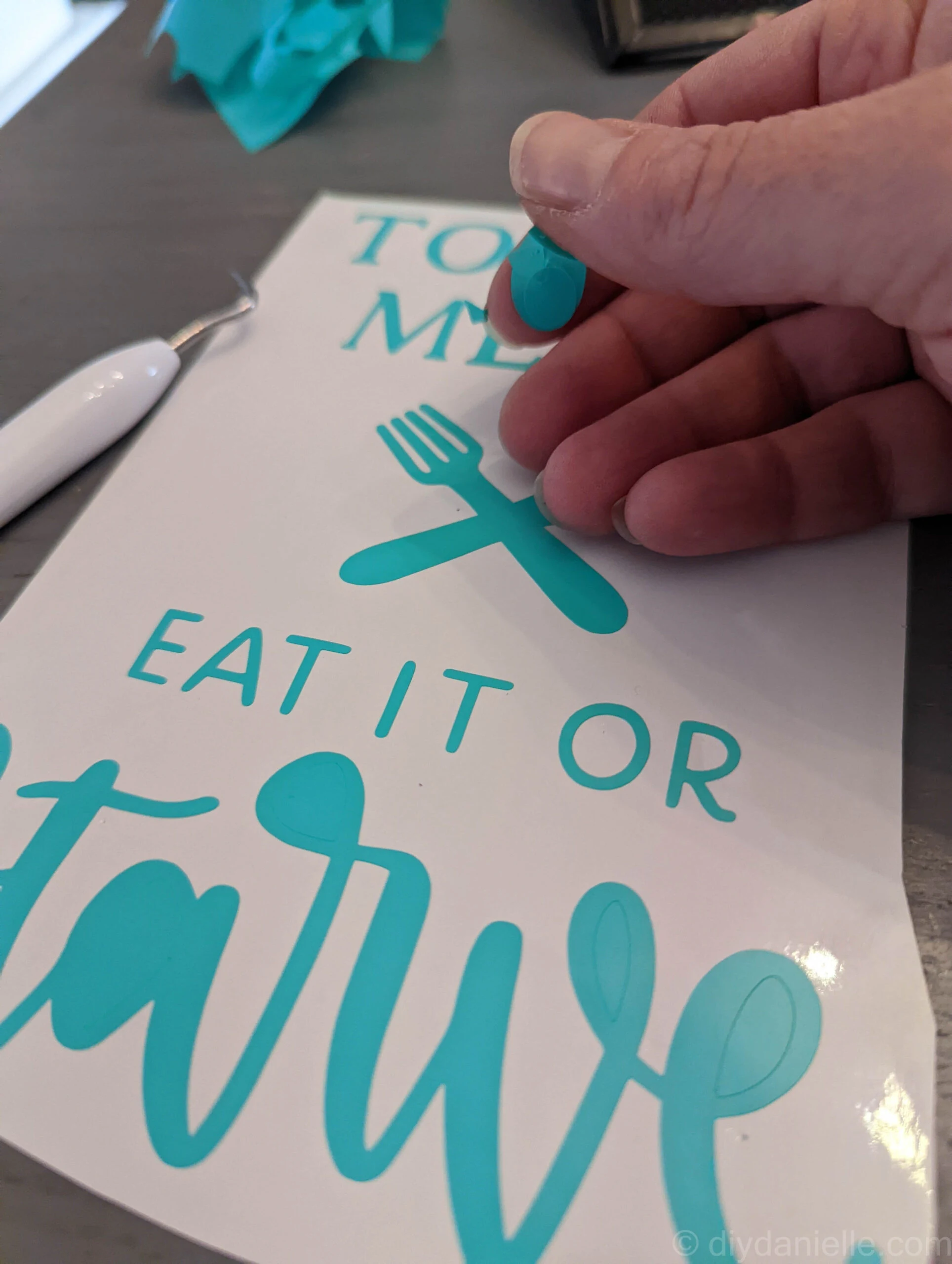 Weeding a wall decal that says "eat it or starve."