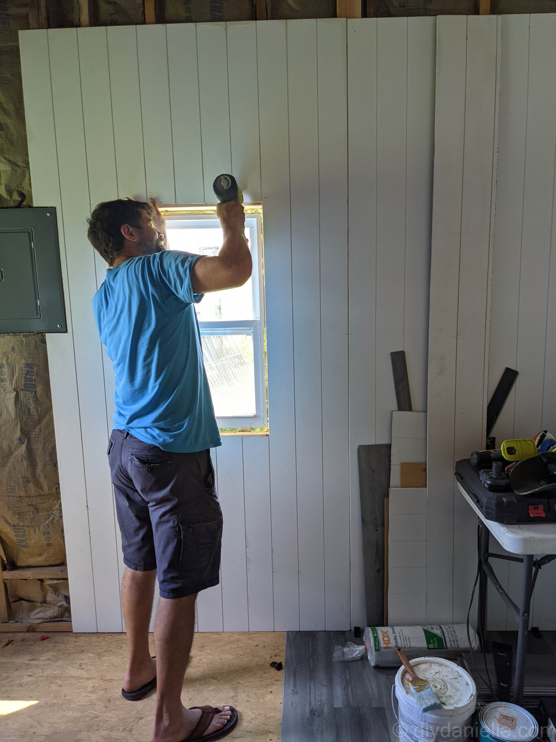 Using the Airstrike to attach the panels to the studs around the window.