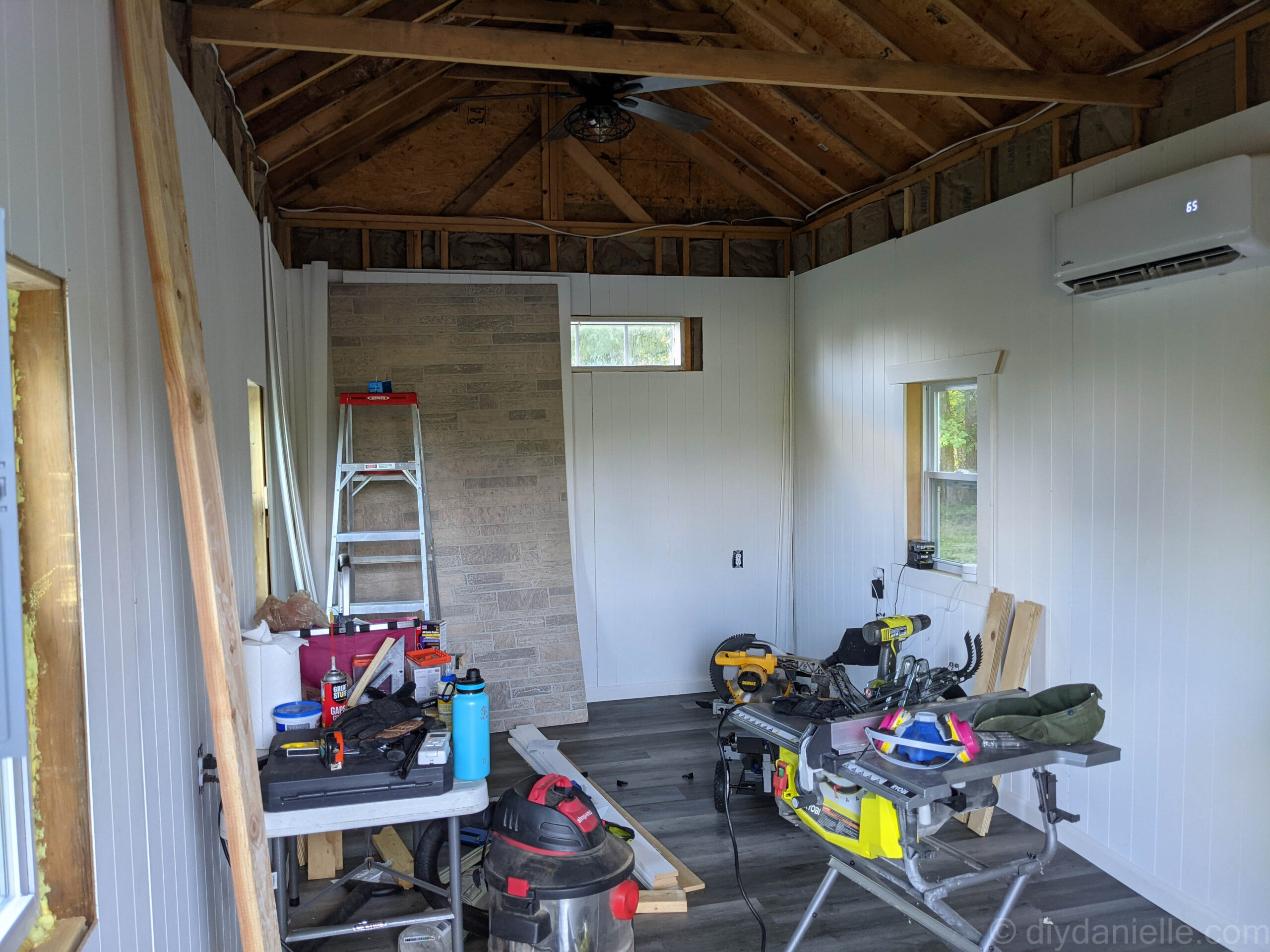 White wall paneling installed with a small area cut out too much around a long horizontal window. We eventually fixed this by adding window trim. 