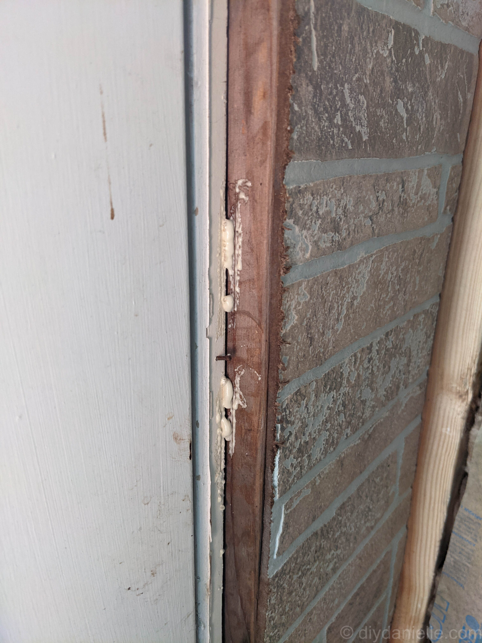 Filling gaps around the door frame with spray foam insulation.