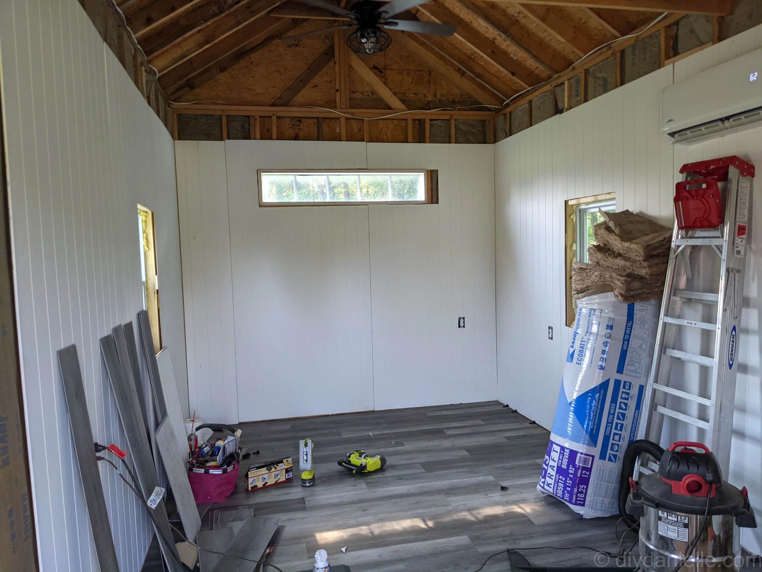 Close-up of vinyl plank flooring installation with spacers still in place along the edges before final removal.
