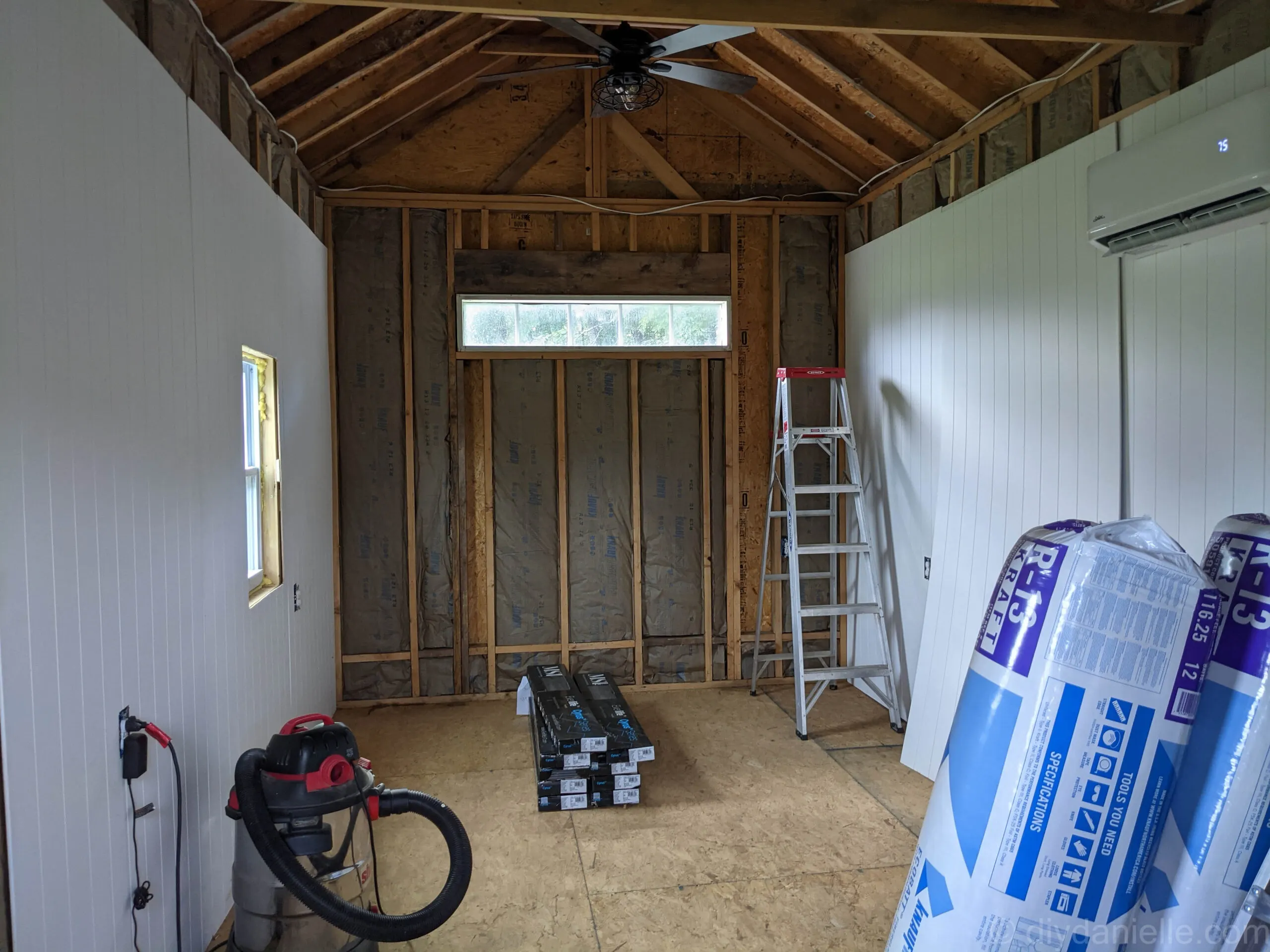 Cleaning and repairing wood subfloor before installing vinyl plank flooring, filling gaps and hammering nails.