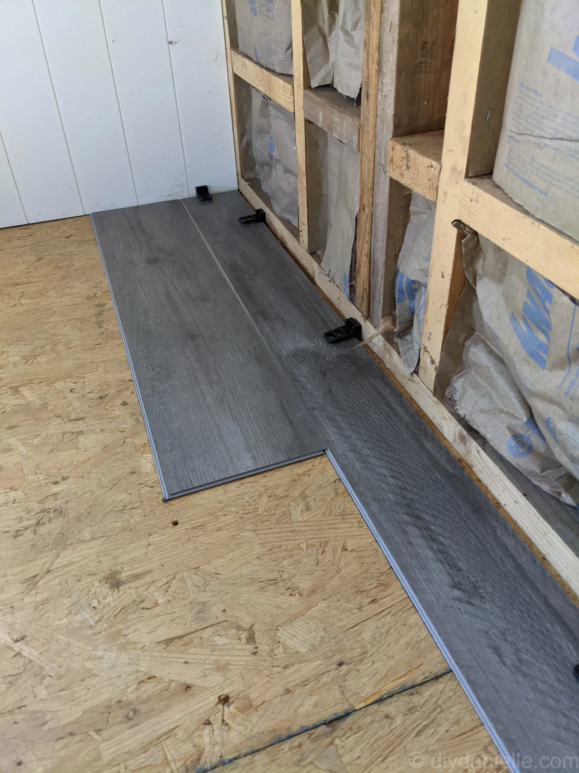 Vinyl plank flooring installation showing first and second rows fitting snugly together.