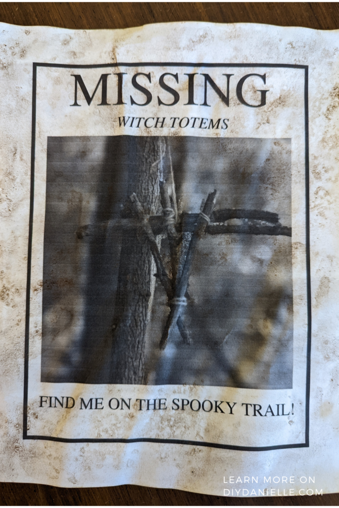 Yellowed sign made for a haunted trail. Sign says "Missing: Witch Totems. Find me on the spooky trail!"