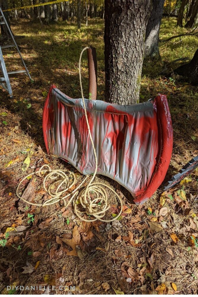 Bloody axe leaning up against the tree.