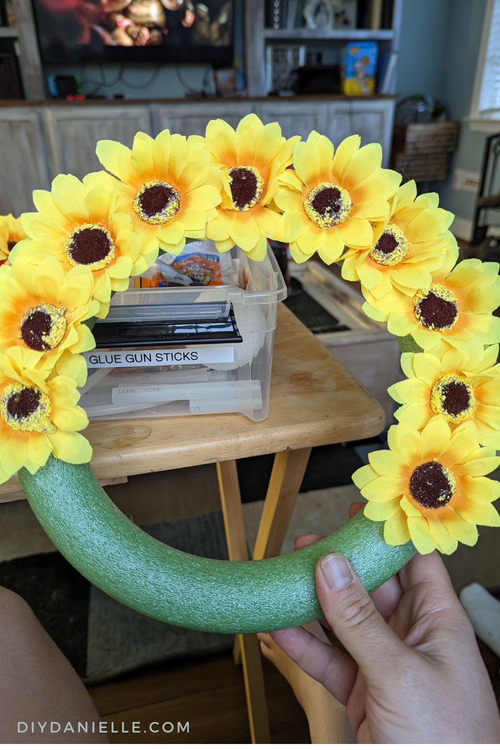 Adding sunflowers  to a foam wreath form.