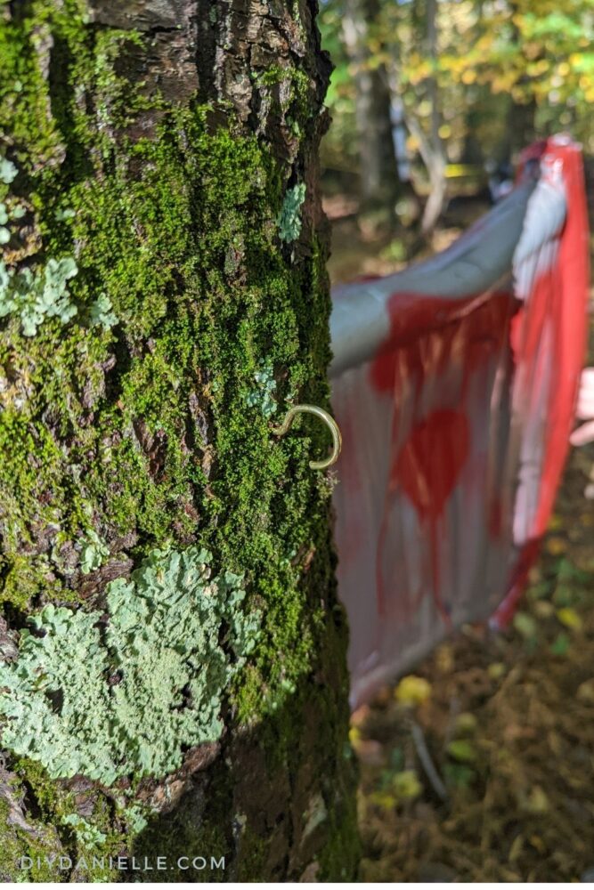 Hook screwed into a tree to hold the rope for the axe.