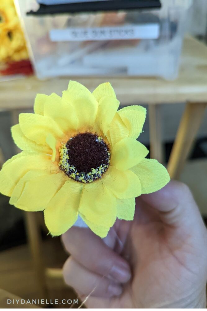 First faux sunflower added to the stryofoam ball. 
