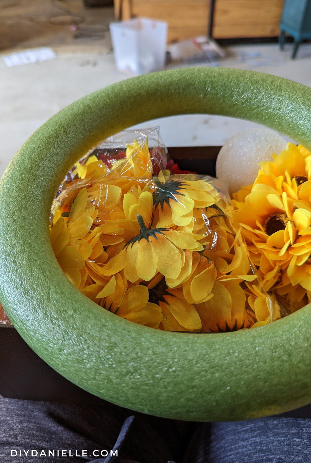 Green foam wreath form from Dollar Tree, sunflowers to make Fall wreath.