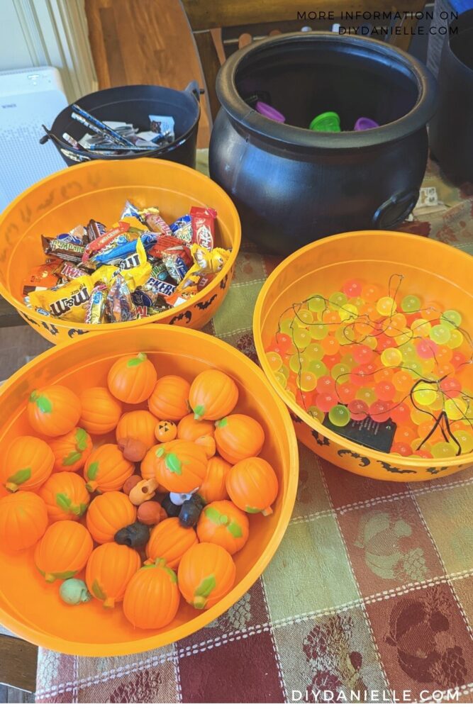 Bins of treats for Halloween. I added fairy lights in the bin with bouncy balls to make them sparkle in the night.