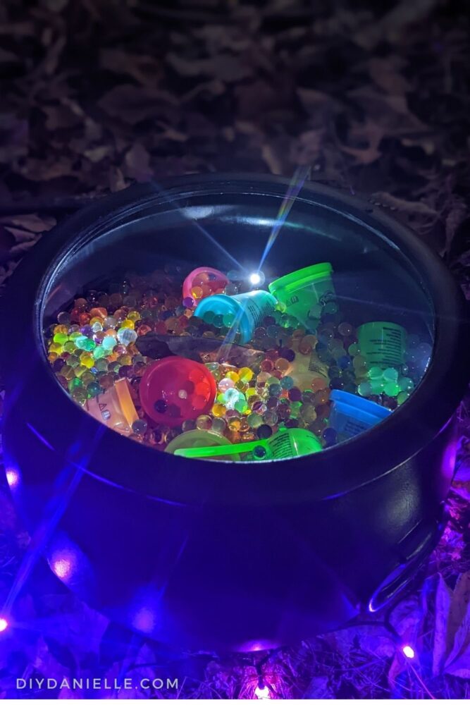Cauldron full of water beads, some spooky lights, and playdoh for 'treats'