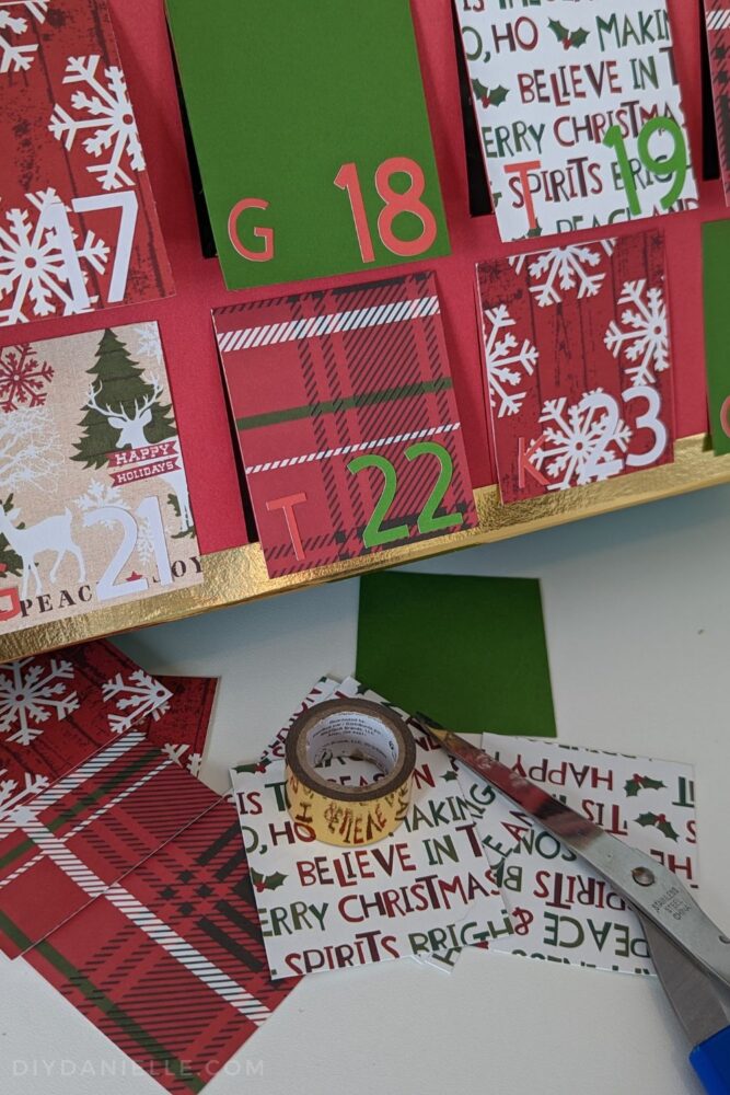 Letters G, K, and T in red Cricut Smart Sticker cardstock, used for noting which child is opening the window that day on an Advent Calendar.