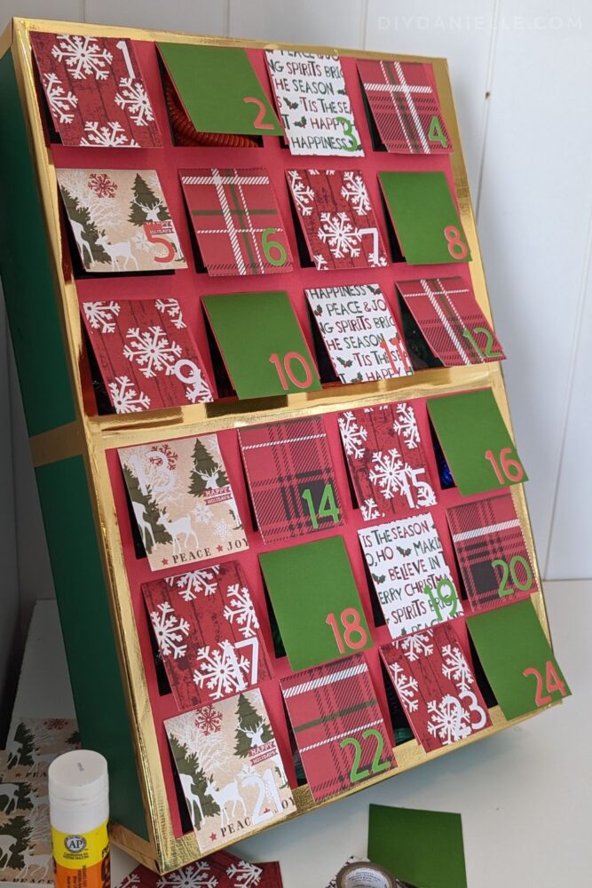 Advent Calendar made with my Cricut Maker 3, scrapbook paper, and a wood box.