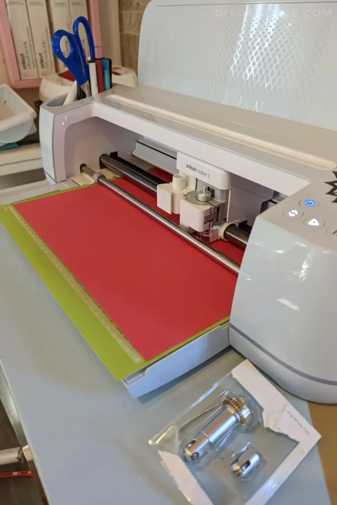 Cutting regular red cardstock on the Cricut Maker 3 for the base of the front for an Advent Calendar.