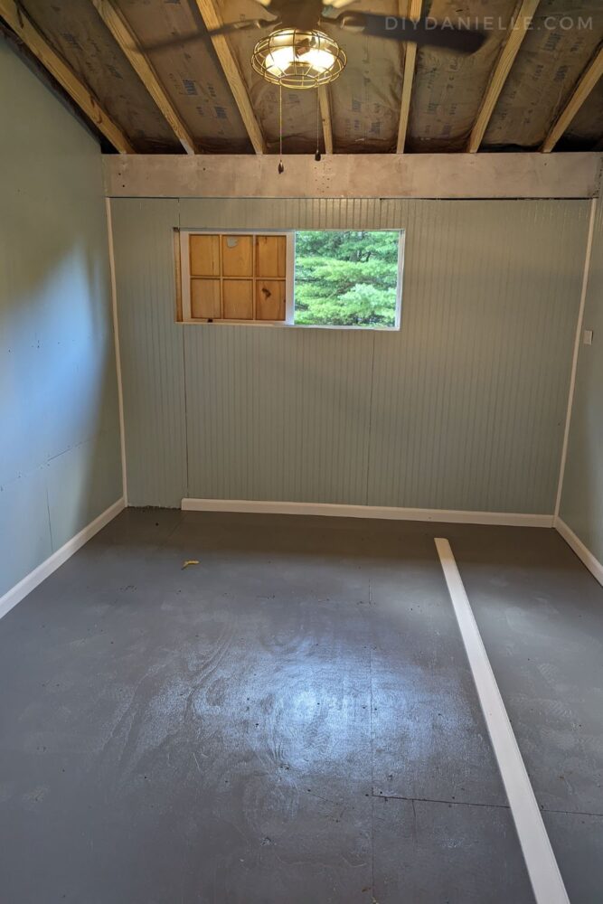 Installing baseboard on the tack room floor.