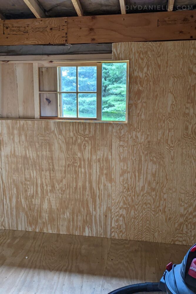 Plywood siding plybead panels on the walls of the tackroom, installed over insulation.