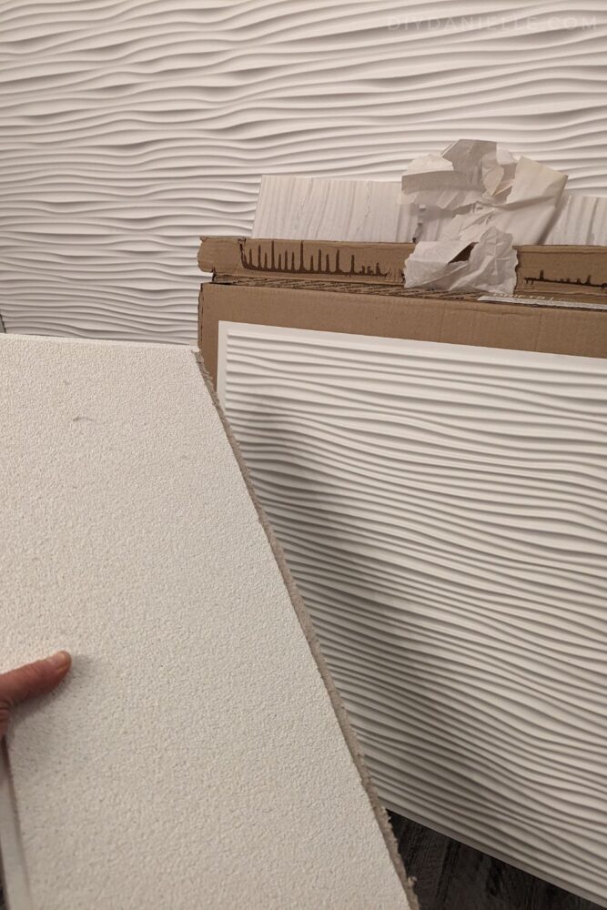 Comparison between the cardboard type of drop ceiling tiles which are thicker and heavier VS. the Genesis ceiling tiles (in the back) which are thin, waterproof, and easy to wipe down.
