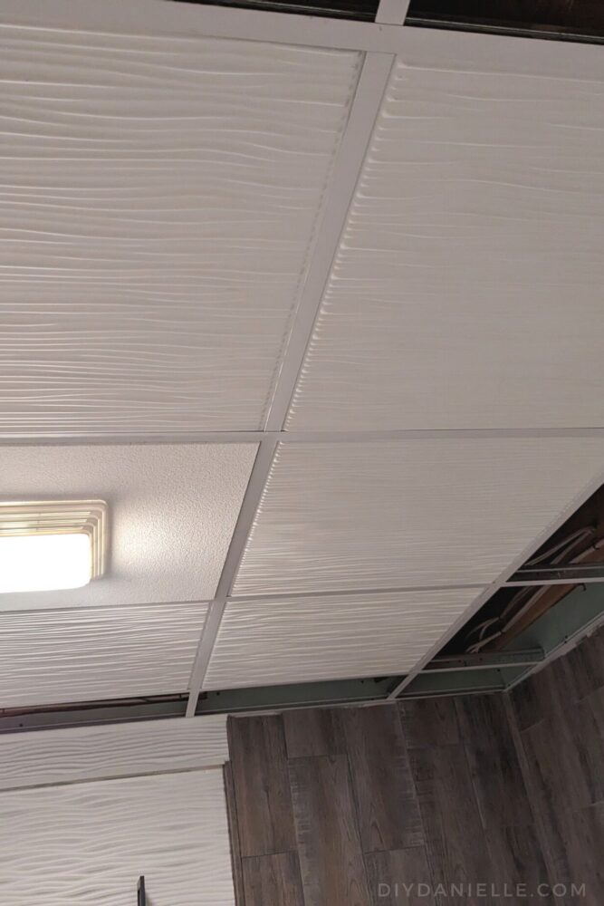 Full panels being installed on a drop ceiling. I saved the cut pieces for last, seeing they're the most difficult.