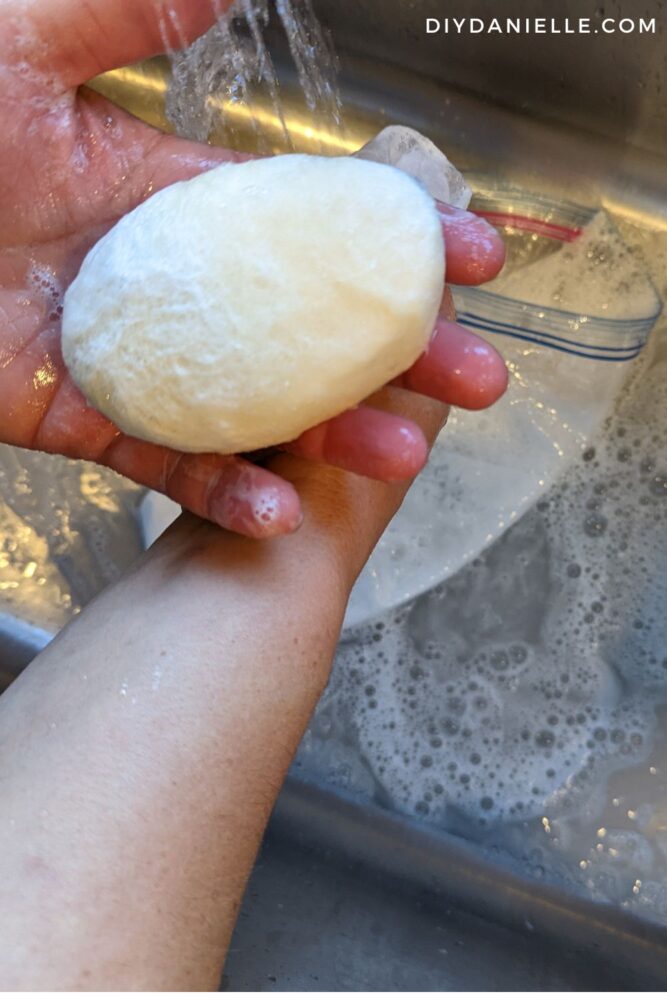 Soap that is in the process of wet felting with undyed wool.