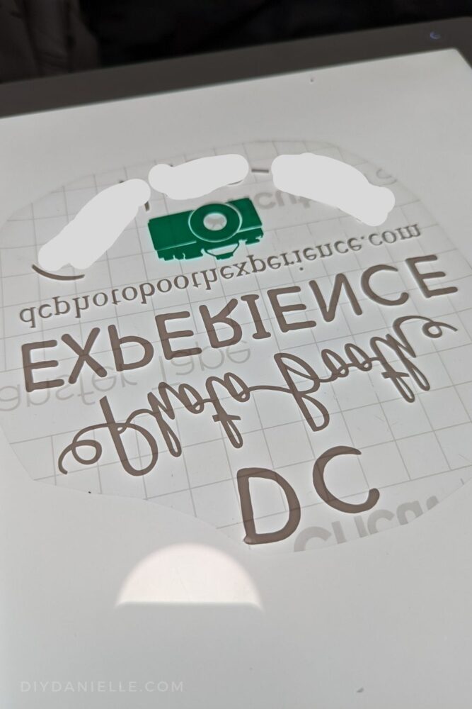 Full design with teal camera and white text, placed on transfer tape.