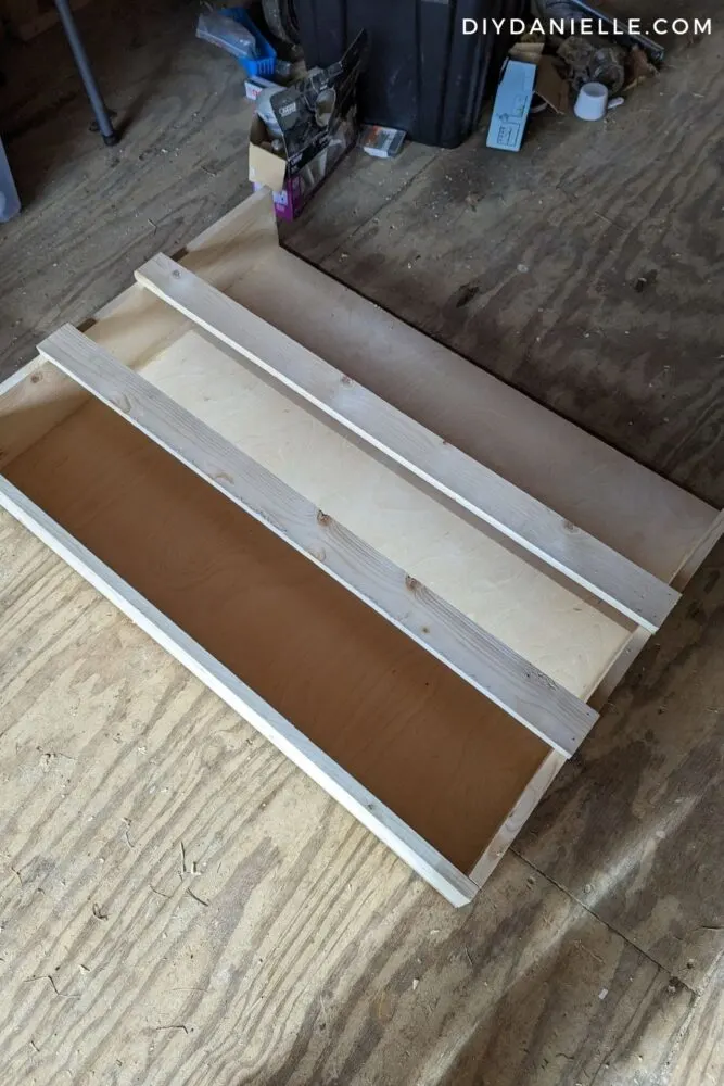 This is my Nerf gun shelf completed before priming and painting it. There are (3) cut pieces of 1x6 that form a U, and a 1/4" piece of plywood behind it. Then I added (2) 1x3s to the front to hold the Nerf guns in.