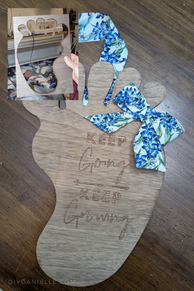 I made a wood foot wreath for my friend that says "Keep Going, Keep Growing." It has blue and green floral ribbon tied in a bow in the corner and a ribbon to hang it with. 

In the left top corner, I have another image of the wood left from the cut. This will make an excellent stencil! 

This was engraved with the M1 Laser Cutter.