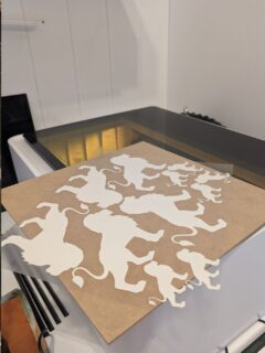 How to Laser Cut Heat Transfer Vinyl... photo of a weeded square of lions that were cut out of yellow HTV.