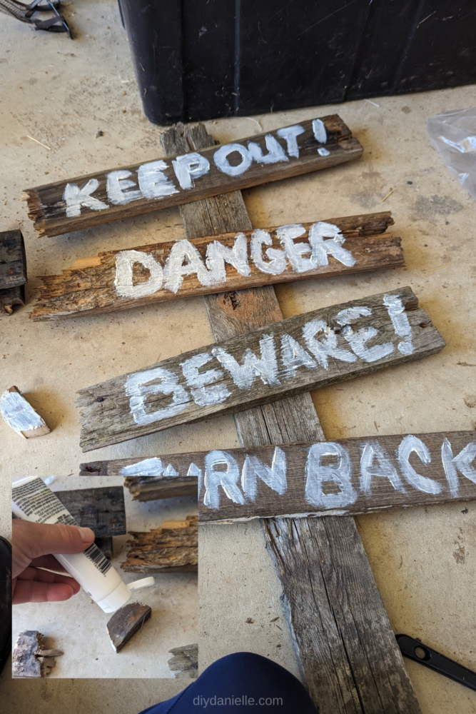Painting onto the pallet wood to create a spooky sign- "Keep out!" Danger "Beware!" Turn back.