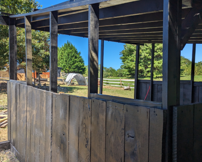 Side view of the black goat and sheep shed.