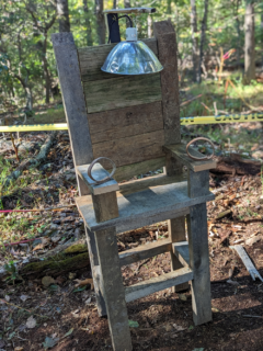 DIY electric chair made from old pallet wood. Photo is of the Halloween decoration setup on our halloween trail.