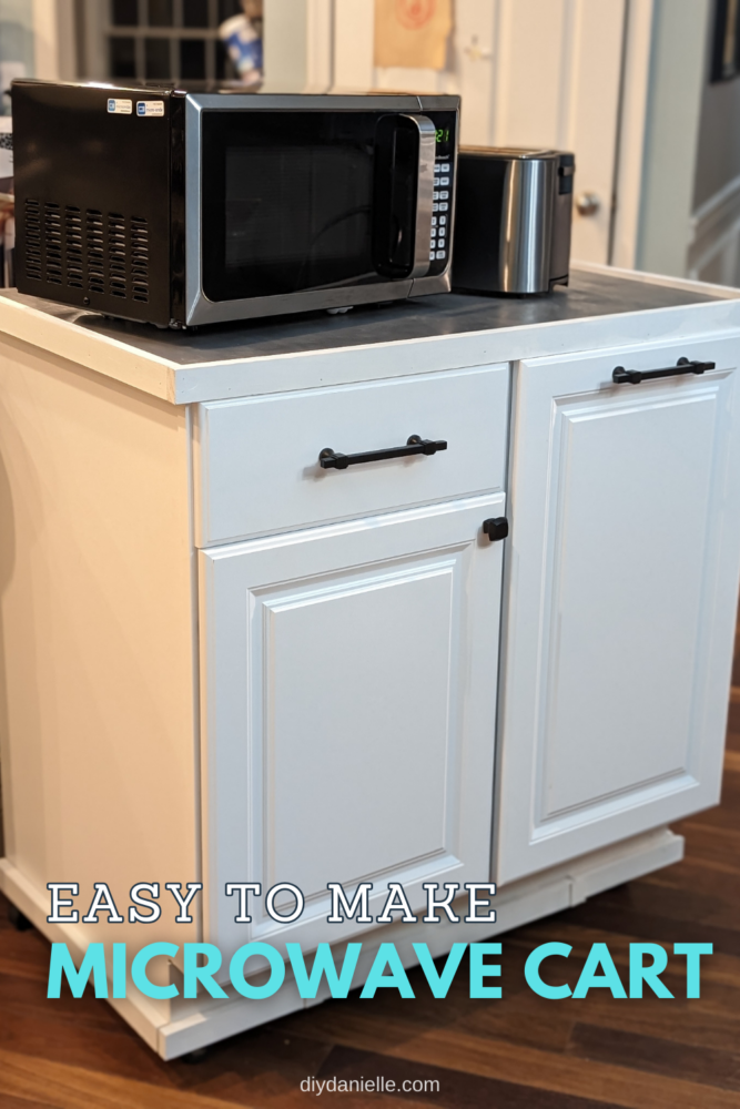 The full DIY microwave cart with wheels, appliance storage, and garbage can storage, with the stainless steel microwave and toaster on top.
