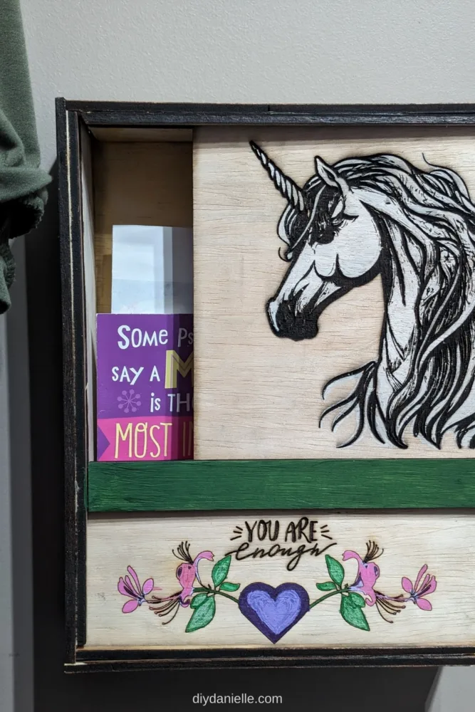 A look at the memory box with the slide panel partially open, revealing the storage space and keepsakes inside.