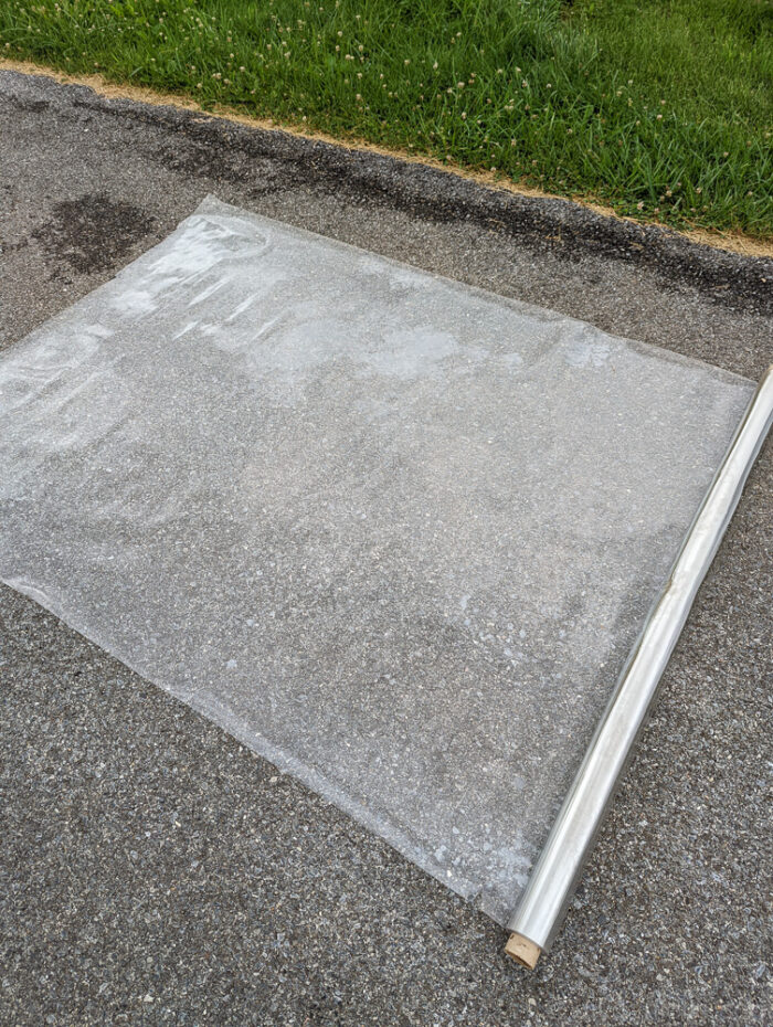 a clear plastic laying flat outside.