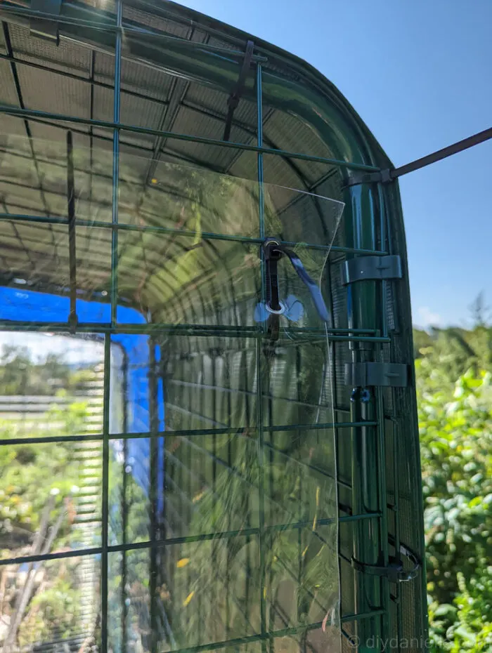 a clear tarp that has been attached to metalic type green house