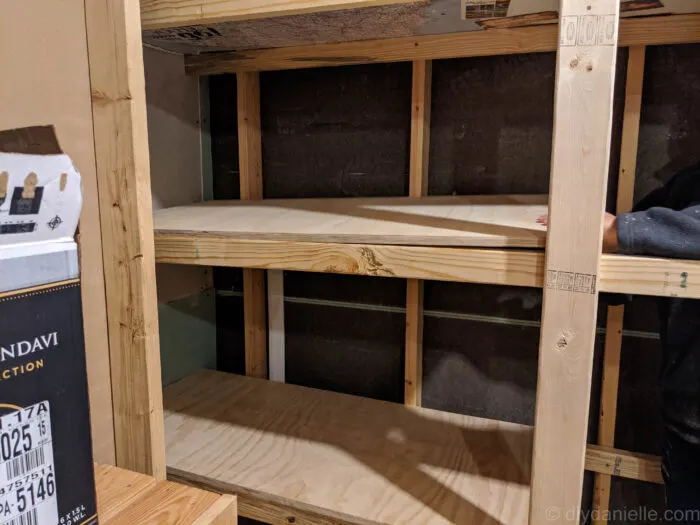 a close-up photo of the not yet finished layered diy basement storage