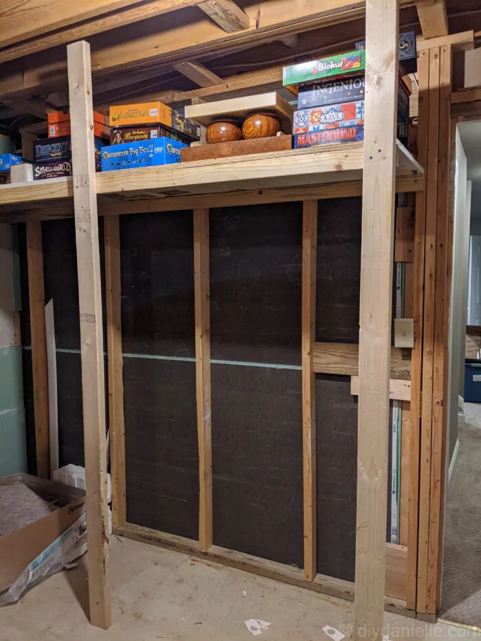 top shelf of the diy basement storage with multiple boxes place on it