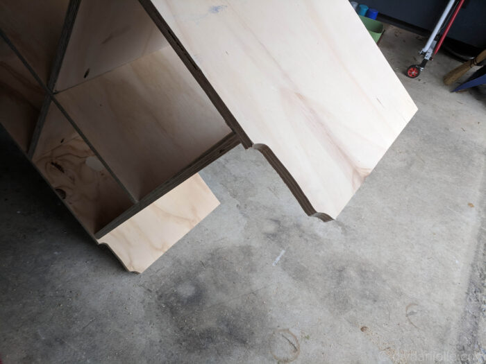 The back of the shelves cut at an angle to curve around the baseboard.