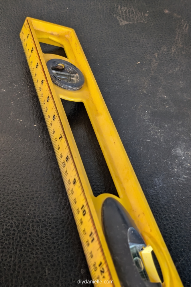 This long yellow tape measure is designed with a smooth, straight edge for easy handling. It features tactile markings, allowing users to feel the measurements as they extend the tape. The bright yellow color makes it easy to identify for those who can see.